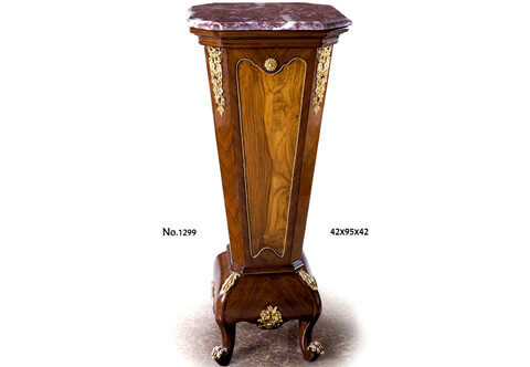 A handsome Italian Louis XVI Transitional style ormolu-mounted and veneer inlaid octagonal shaped Pedestal Stand; Surmounted with an octagonal shaped canted corners leveled marble top above a Cyma Recta Cavetto style leveled Cornice above the tapering form octagonal shaped body which finely double sans-traverse veneer inlaid; the recessed scalloped shaped central panels are framed with spiral ormolu bands and centered at top with most decorative ormolu rosette on each side; flanked with a finely chiseled pierced ormolu chutes of suspending ribbon-tied blossoming foliate mounts; The central support is on a leveled astragal above a sans-traverse veneer inlaid bombé shaped curved plinth centered with a marvelous pierced ormolu bouquet of blossoming flowers and flanked with protruding corners adorned with ormolu acanthus leaves extended to the bold cabriole volute legs ornamented with fine scrolling ormolu acanthus leaves mounts.