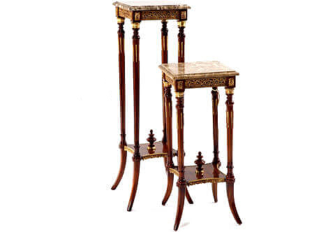 A tasteful French early 19th century Louis XVI style ormolu-mounted tall square shaped Pedestal Table after the model by François Linke; The upper tier is surmounted with a mottled border square marble top above a conforming frieze ornamented with stunning pierced foliate scrolled Rinceau shaped ormolu movements of richly chased acanthus leaves and separated above each support by a wooden block inlaid with a rectangular ormolu rosette to each; all above two levels ormolu and wooden mottled caps following to four circular tapering fluted supports adorned with delicately fitted ormolu chandelles and terminated with other mottled caps; The supports are connected in the lower section by concaved sides veneer inlaid lower tier forming an X-stretcher embellished with a central topie shaped finial and accented on sides with finely chiseled ormolu band of draped fabrics and tassels design surmounted with a beaded pattern; all above the splayed tapering robust legs. The elegant pedestal table is available in two sizes per request as displayed.