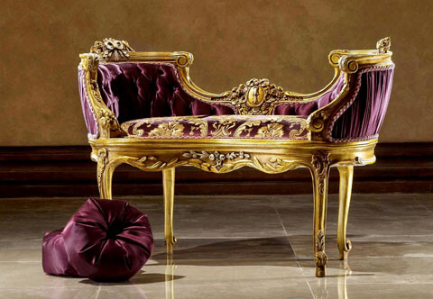 A Royal Opulent French Louis XV Rococo style hand carved, French foil gilded and French silver foil parcel silvered Loveseat Mini Sofa; The luxurious sofa is hand carved with Rococo elements, full of swags, foliate garlands, acanthus leaves, blossoms, branches and tied-ribbons, centered with an imitation of a royal emblem medallion; Upholstered with elegant silk purple fabric on the back with a tufted finish and with matching purple golden fabric to the seat; The beautiful mini sofa is raised on delicate cabriole legs with turned feet ornamented with foliate acanthus sabots.