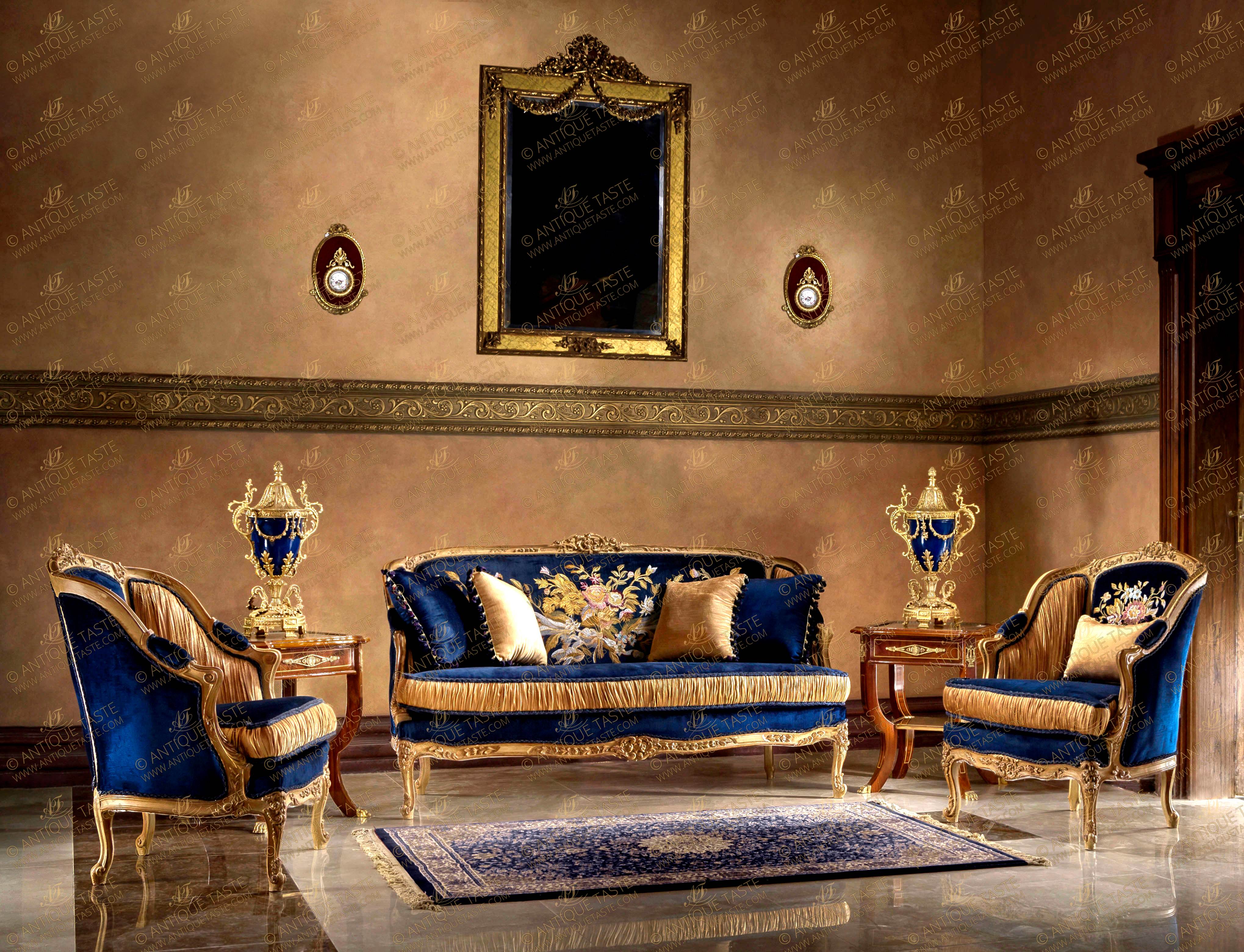 A stylish and chic French Louis XV style living room Settee Set of three pieces, hand carved, cream color painted, patinated, aged and scratched, parcel gilt French foil gilded, upholstered in dark blue and beige velvet and hand embroidered in Serma designs; raised on scrolling cabriole legs and finely carved in scrolling C works, blossoming flowers, foliate branches and acanthus leaves