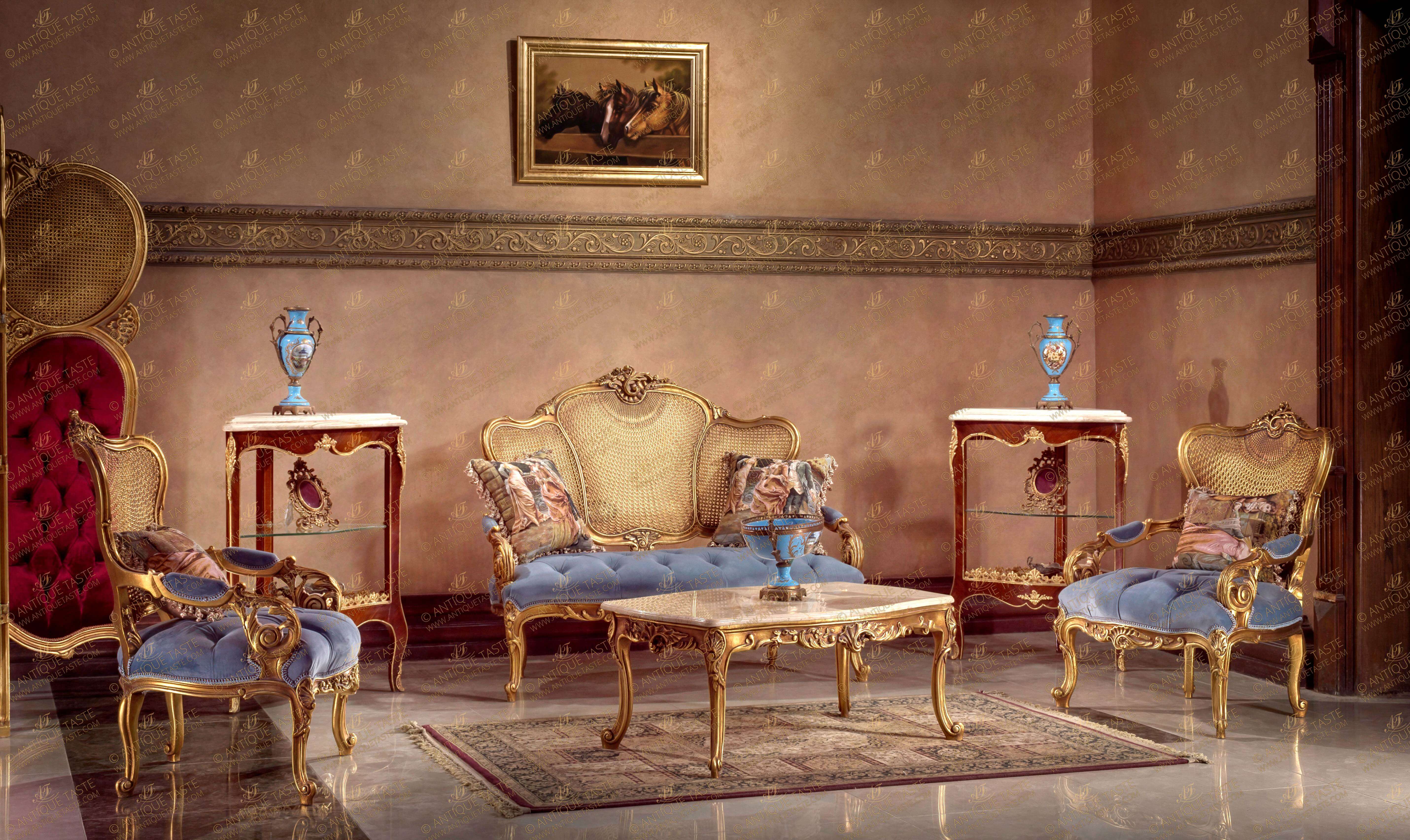 An astounding and breathtaking French Louis XV Rococo and Rocaille style four pieces Petite Salon Set; comprising of one sofa, two armchairs and one center coffee table; caned finish, elaborately hand carved, French foil gilded and patinated; upholstered in royal light blue velvet in tufted style; the beautiful set have caned back in sunbeam style and splendiferously hand carved with pierced Rocaille elements, C scroll works, sea shells, harmonious large acanthus leaves, anthemions, foliate petal carvings and raised on splayed cabriole legs on scrolling sabots