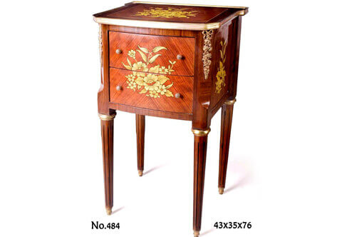 A French Louis XVI style ormolu-mounted foliate marquetry and veneer inlaid two drawers Night Stand; ornamented with flower bouquet marquetry patterns and ribbon tied ormolu chutes