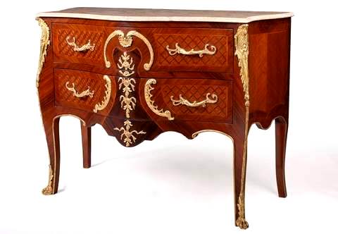 An exceptional French Regency Rococo style ormolu-mounted parquetry inlaid commode à Vantaux after the model by Charles Cressent, Paris, circa 1730, executed by Frederic-Louis Durand and Fils, With a serpentine shaped marble top above a bombé front with two conforming long drawers sans traverse and trellis parquetry veneer inlaid ornate at the top by an ormolu shell figure flanked by ormolu C-scrolls surmounting a suspending foliate trail, flanked by twisted foliate C scrolls and four foliate handles, the lower contour adorned with ormolu bands, the angles headed by large trellis cast acanthus leaves mounts on chute-edged tapering legs ending in clawed acanthus feet sabots