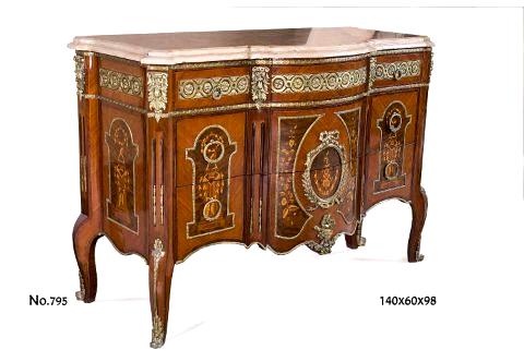 A transitional French marquetry commode, after the model by Pierre Antoine Foullet, late 19th century, with featured molded and shaped marble top above ormolu engraved bands on two small drawers to each side supported by a conforming case of two larger drawers, with ormolu mounts ornamentation of ormolu bands, foliate ormolu mounts and ribbons, light and dark inlays of marquetry and veneers raised on cabriole legs with foliate ormolu cast sabots