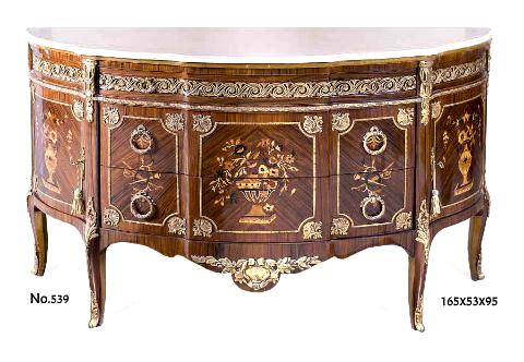 French earlier rococo, Louis XV style ormolu mounted commode after the model by Roger Vandercruse Lacroix under the direction of Gilles Joubert, Paris, 1769, inlaid with pictorial marquetry, eared marble topped, oval shape, classical motifs, large apron, fine ormolu mounts, three drawers and two doors, raised on ormolu mounted cabriole legs