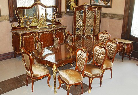 An alluring French late 19th Century Louis XV style eleven pieces luxury Dining Room Set after the model by François Linke, sensationally ormolu-mounted with finely chiseled scrolling foliage, waterfall, cresting, acanthus leaves, swaging garlands, hammered ormolu bands and sophisticated pierced ormolu works; inlaid in double sans-traverse veneer, foliate marquetry patterns and harmonious diamond parquetry; comprising of a dining table, eight dining chairs, buffet with mirror and china cabinet.