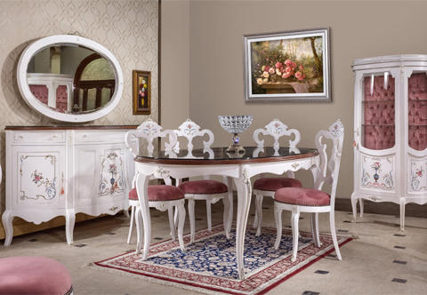 A delightful French Louis XV style nine pieces luxury Dining Room Set comprising of a dining table, six pierced back dining chairs, one D shaped buffet with mirror and one velvet tufted upholstered back display cabinet, the delicate set is highly white lacquered and hand painted and decorated by our artists with wonderfully executed and finely detailed scrolled foliate designs with tied ribbons, flower urns and charming vividly colored leaves and foliage, the set is finely embellished with silvered ormolu mounts of acanthus leaves, scrolling mounts, silvered ormolu bands, suspending garlands, circular rosettes, foliate cresting cabochons and ribbon-tied bay-leaves.