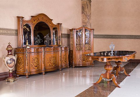 A distinctive French Napoleon III style eleven pieces grand Dining Room Set; distressed ormolu-mounted with large acanthus leaves chutes, ormolu trims, ormolu bands, leafy ormolu cabuchon and suspending swaging laurel wreath garlands; inlaid with sans-traverse double veneers and harmonious foliate marquetry patterns; comprising of a pedestal dining table, six dining chairs, pair of arm chairs, grand buffet with mirror and one display cabinet.