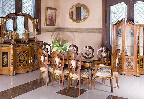 A dignified Napoleon III Louis XVI Revival style eleven pieces Dining Room after the model Circa 1865; splendidly ormolu-mounted, ebonized, sans-traverse rosewood veneer and floral bouquet marquetry inlaid; ornamented with different shapes of rosettes, square rosettes, oval rosettes and circular rosettes, scrolling acanthus pierced works, acanthus chutes, ormolu bands with a draped fabric and tassel design and ormolu acorn finials; the fine set is comprising of a pedestal dining table, six dining chairs, pair of armchairs, buffet with mirror and display cabinet.