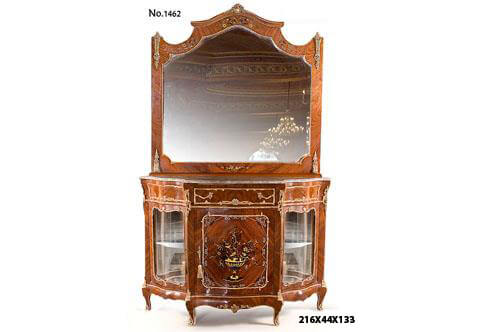 A fabulous French Transitional style ormolu-mounted veneer and marquetry inlaid entrance console cabinet with a matching mirror after the model by Henri Picard (1840-1890), The domed top scalloped shaped mirror frame crested with central ormolu cabuson mount, cornered on top and bottom by a fine chiseled foliate ormolu chutes, the top and bottom frieze are inlaid with delicate foliage marquetry patterns. The internal mirror border shaped and bordered in ormolu C scrolls strips, Resting on a serpentine shaped cabinet marble top above the apron with central drawer bordered with foliate scrolled ormolu trim and foliate handles, flanked by exquisite pierced acanthus ormolu chutes, the sides has the same ormolu trim as well,  The lower part has three doors, the central door has an inset panel with high quality exoticwood floral detailed marquetry with scrolled marquetry border within a leafy ormolu border and ormolu keyhole escutcheon, the mirrored back two doors on each side with one tier and glass front within a scalloped foliate border and ormolu keyhole escutcheons, all above a scalloped shaped apron, The cabinet is raised on short cabriole legs ornamented with delicate chiseled gilt ormolu acanthus mount elongated with ormolu trim to the pierced foliate ormolu sabots, the contour of the apron decorated with an ormolu strip and foliage ormolu mounts to the central part