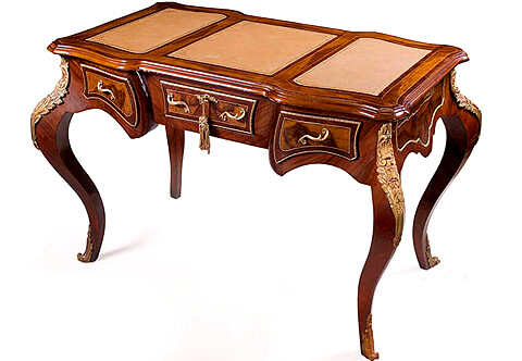 French Louis XV style Ormolu-mounted veneer inlaid three drawers Bureau De Dame, three sectional leather top surface, The sides and drawers are veneer inlaid with the precious mahogany and surrounded with delicate ormolu band and foliate scrolled ormolu handles, the central drawer with ormolu foliate keyhole escutcheon, Raised on cabriole legs cornered with fine ormolu foliate chutes in an exceptional satin and burnished finish and terminating with turned ormolu sabots, The desk is available with a matching classic office chair