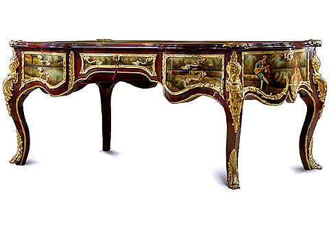 French 19th century Louis XV and Vernis Martin style ormolu-mounted veneer inlaid Executive decorative Bureau Plat, the scalloped surface with moulded border cornered at the four angles with gilt ormolu foliate lyre and seashell shaped cast clasps and three sectional scalloped gilt-tooled leather top, the frieze below has five drawers, with delicate foliate handles, and all bordered with intricately chiseled foliate ormolu trims, the central recessed drawer with foliate ormolu keyhole escutcheons. On each side of the central drawer, vertical acanthus gadroon shaped ormolu chutes elongated with ormolu fillet wrapping around the contour of the whole desk, at each corner extraordinary and richly chiseled large gilt-ormolu female figure chutes adorned with scrolls and a feather headdress, the sides with finely ornamented with foliate scrolled ormolu encadrements terminated with C shapes harmonized with the scalloped apron below, the drawers, the sides and the back are beautifully hand painted by our artisans with romantic court scenes and outdoor natural landscapes on the François Boucher manner, the desk is raised on four bold cabriole legs with exquisitely chased ormolu leafy paw sabots