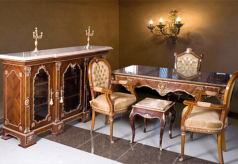 A fine 18th century French Louis XV style gilt-ormolu-mounted veneer inlaid Bureau Plat, The desk is raised on robust curved cabriole legs each is terminated with ormolu acanthus volute sabots and topped with exquisite gilt-ormolu crowned female busts on foliate chutes body, The writing surface with gilt-tooled leather top surrounded with gilt-ormolu gallery and cornered with finely chiseled foliate ormolu clasps surmounting a frieze below of three scalloped shaped drawers, bordered with foliate ormolu filets in a satin and burnish finish and each drawer is ornamented with a fine cast gilt-ormolu Satyr Mask amidst foliate patterns, The central drawer with ormolu keyhole escutcheon above the mask, On the reverse and sides are three similar decorative drawers and design, The desk is available in other veneer finishing and silvered ormolu casting per request