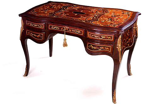 A French Louis XV style ormolu-mounted marquetry and veneer inlaid five drawers Lady’s Desk marquetry eared top above a scalloped shaped palisander veneered frieze with five drawers two drawers to each side and central larger drawer with ormolu foliate keyhole escutcheon all drawers are foliate marquetry inlaid with and ornamented with an ormolu strip and delicate foliate ormolu handles The sides are marquetry inlaid with scrolled flower patterns and bordered with a hammered ormolu band as well The desk is raised on cabriole legs headed with acanthus leaves ormolu chutes and terminated with richly chased folium ormolu sabots The desk is available with a matching elegant Louis XV style chair