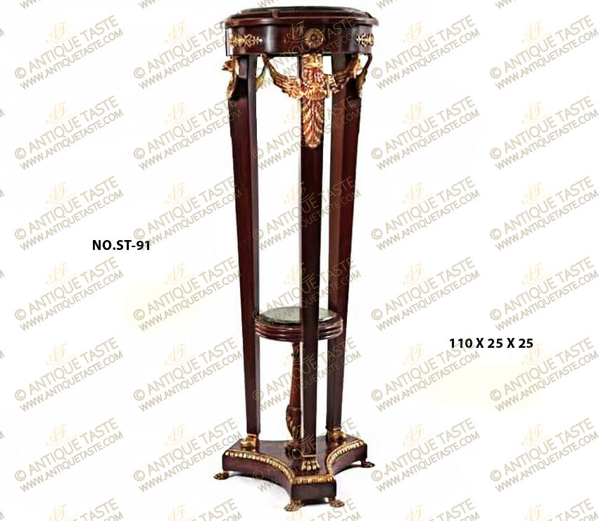 A dignified French 19th Century Empire style ormolu-mounted and veneer inlaid Pedestal Stand after the model by François-Honoré-Georges Jacob-Desmalter; raised on a triform concaved sides plinth with pair of ormolu lion paw feet to each of its corners and adorned with Egg-and-Dart ormolu trim on the edge, above are three tapering slender supports resting on another style of ormolu lion paw feet and surmounted with finely and masterfully chiseled winged eagle on an ormolu acanthus spinosus leaf extension; the upper circular tier is ornamented with circular ormolu rosettes and pierced floral ormolu mounts; the surmounting protruding top part has and inset marble top surrounded with pair of twisted ormolu bands and decorations of ormolu acanthus spinosus leaves; the three supports surrounding a central marble topped Tazza as a stretcher resting on a baluster shaped foot and ornamented with ormolu twisted bands and ormolu acanthus leaves.