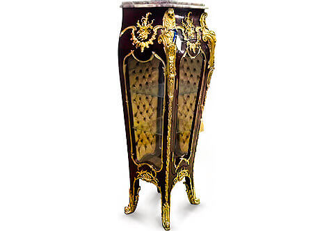 A splendid French early 20th century Louis XV Rocaille style ormolu-mounted veneer inlaid grand Royal Vitrine Stand after the model by François Linke, Paris; Surmounted with a moulded marble top above a concave section ornamented with a fascinating acanthus C scrollworks and blossoming acanthus leaves medallion, all above tapering sides with three convex molded glazed panels framed with sensational ormolu foliate fillet; each corner is exceptionally adorned with impressive richly chased foliate chutes mounts with scrolling C acanthus leaves, shells and crossing bands in a striking satin and burnished finish elongated with fine leafy trims to the legs and connected with suspending festooned foliate shell mounts, with one door houses two glass shelves having velvet tufted upholstered back and ormolu foliate keyhole escutcheon; The magnificent piece stands on tapering splayed legs and terminating in wrap around scrolled acanthus sabots. The curved bottom contour with foliate ormolu filet and mounted with richly chiseled foliate and waterfalls ormolu mounts.