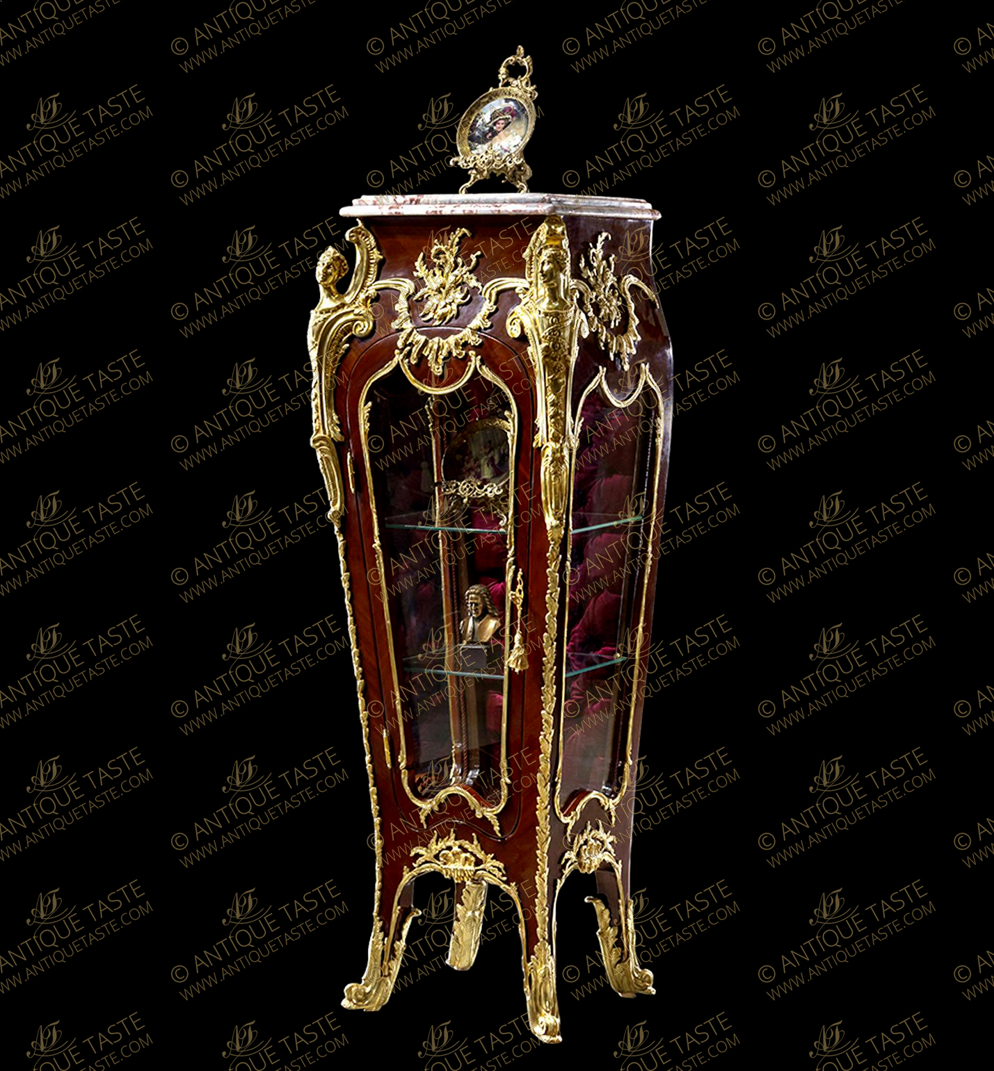 Our elaborate replica of the French Louis xv style gilt-ormolu-mounted veneer inlaid kingwood and mahogany Luxury Vitrine Stand after the model by Francois Linke, Paris, early 20th century; With variegated moulded marble top above tapering sides with three convex molded glazed panels framed with a gilt-ormolu foliate strips below astonishing large gilt-ormolu chute with female espagnolette at each foremost angle with acanthus shell scrolls and C works, elongated with fine leafy trim to the legs and connected with suspending festooned foliate shell mounts, with one door houses two glass shelves having velvet capitoné upholstered back and ormolu foliate keyhole escutcheon, stands on tapering legs and terminating in wrap around scrolled acanthus sabots. The curved bottom contour with foliate ormolu filet and mounted with richly chiseled foliate and waterfalls ormolu mount. EXCEPTIONAL PIECE OF ART.