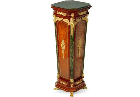 A sublime French early 19th century Empire Neoclassical style distressed ormolu-mounted marble topped light sans traverse palisander veneer inlaid Pedestal Stand; The inset octagonal shaped veined black marble top is over a conforming tapered base with further veined black marble supports headed with finely chiseled ormolu winged female bust capitals and ornamented with Neoclassical style ormolu mounts throughout; The fine pedestal is raised on four human feet-form supports. Available in another version with gilt-ormolu mounts and green Indian marble.