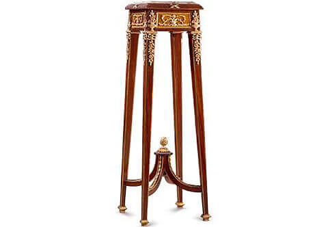  French Louis XVI late 19th century “Belle Époque” style corner Pedestal Table, Surmounted by an inset moulded marble top on a confronting stepped frieze with X shaped ormolu mounts on four sides, The pedestal has tapered square legs decorated by ormolu band on four corners of each leg and sit on ormolu base sabots. Every two sides of each leg are adorned with finely chiseled ormolu chutes or ribbon tied swaging blossoming flower pendants surmounted by ormolu flower vase, The apron between each leg also displays fine and highly chased ormolu mounts of foliate scroll-works within an ormolu border, The legs are joined by a scrolled X shaped stretcher. The stretcher is decorated with foliate ormolu mounts laurel garlands and a central ormolu pine cone