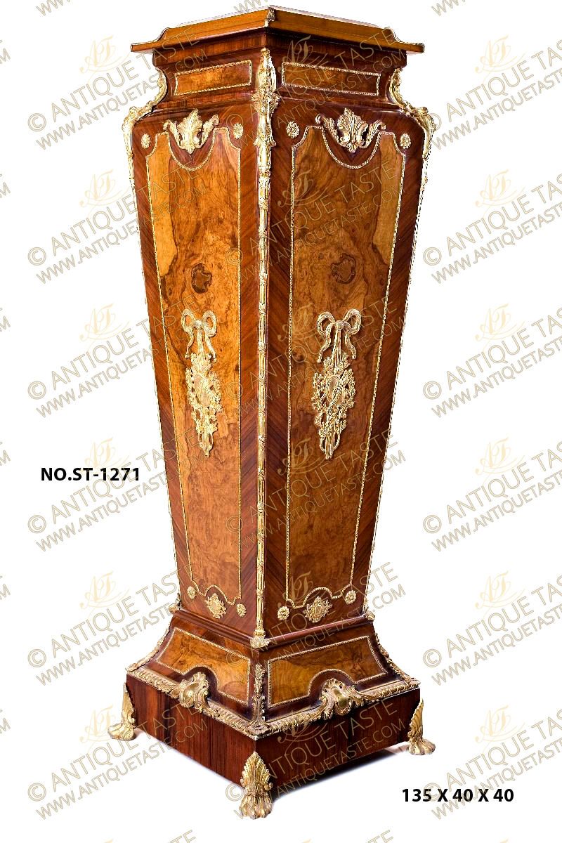 A spectacular and monumental French mid 19th Century Louis XVI style ormolu-mounted and double veneer inlaid marble topped Grand Vase Pedestal Column; The inset marble top within a leveled frieze adorned with leafy ormolu corner mounts extended to concave form decorated with ormolu encadrement and flanked to each corner with superbly chiseled foliate ormolu chutes elongated along the square tapered body with fine ormolu Reel band; each side of the fine pedestal is topped with an acanthus form Cabuchon issuing scrolling foliate branches above a shaped beaded ormolu encadrement cornered on the four angles with circular ormolu rosette, the center has a striking pierced ormolu mount of a suspending ribbon tied quiver and darts within foliate movements; The body lower convex shaped extension above the plinth is doubled veneer inlaid and decorated with beaded ormolu encadrements on the four sides and cornered with marvelous foliate ormolu chutes mounts; the square shaped plinth is beautifully surmounted on upper edges with Ovolo-with-Egg-and-Dart ormolu band centered with fine chiseled Cabuchon of shell and scrolling acanthus foliage and raised on finely chased ormolu hairy paw feet with acanthus leaf mount; The fine pedestal is produced per request in another version with a central ormolu-mounted porcelain Sèvres plate with romantic court scenes as displayed.