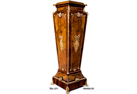 A spectacular and monumental French mid 19th Century Louis XVI style ormolu-mounted and double veneer inlaid marble topped Grand Vase Pedestal Column; The inset marble top within a leveled frieze adorned with leafy ormolu corner mounts extended to concave form decorated with ormolu encadrement and flanked to each corner with superbly chiseled foliate ormolu chutes elongated along the square tapered body with fine ormolu Reel band; each side of the fine pedestal is topped with an acanthus form Cabuchon issuing scrolling foliate branches above a shaped beaded ormolu encadrement cornered on the four angles with circular ormolu rosette, the center has a striking pierced ormolu mount of a suspending ribbon tied quiver and darts within foliate movements; The body lower convex shaped extension above the plinth is doubled veneer inlaid and decorated with beaded ormolu encadrements on the four sides and cornered with marvelous foliate ormolu chutes mounts; the square shaped plinth is beautifully surmounted on upper edges with Ovolo-with-Egg-and-Dart ormolu band centered with fine chiseled Cabuchon of shell and scrolling acanthus foliage and raised on finely chased ormolu hairy paw feet with acanthus leaf mount; The fine pedestal is produced per request in another version with a central ormolu-mounted porcelain Sèvres plate with romantic court scenes as displayed.