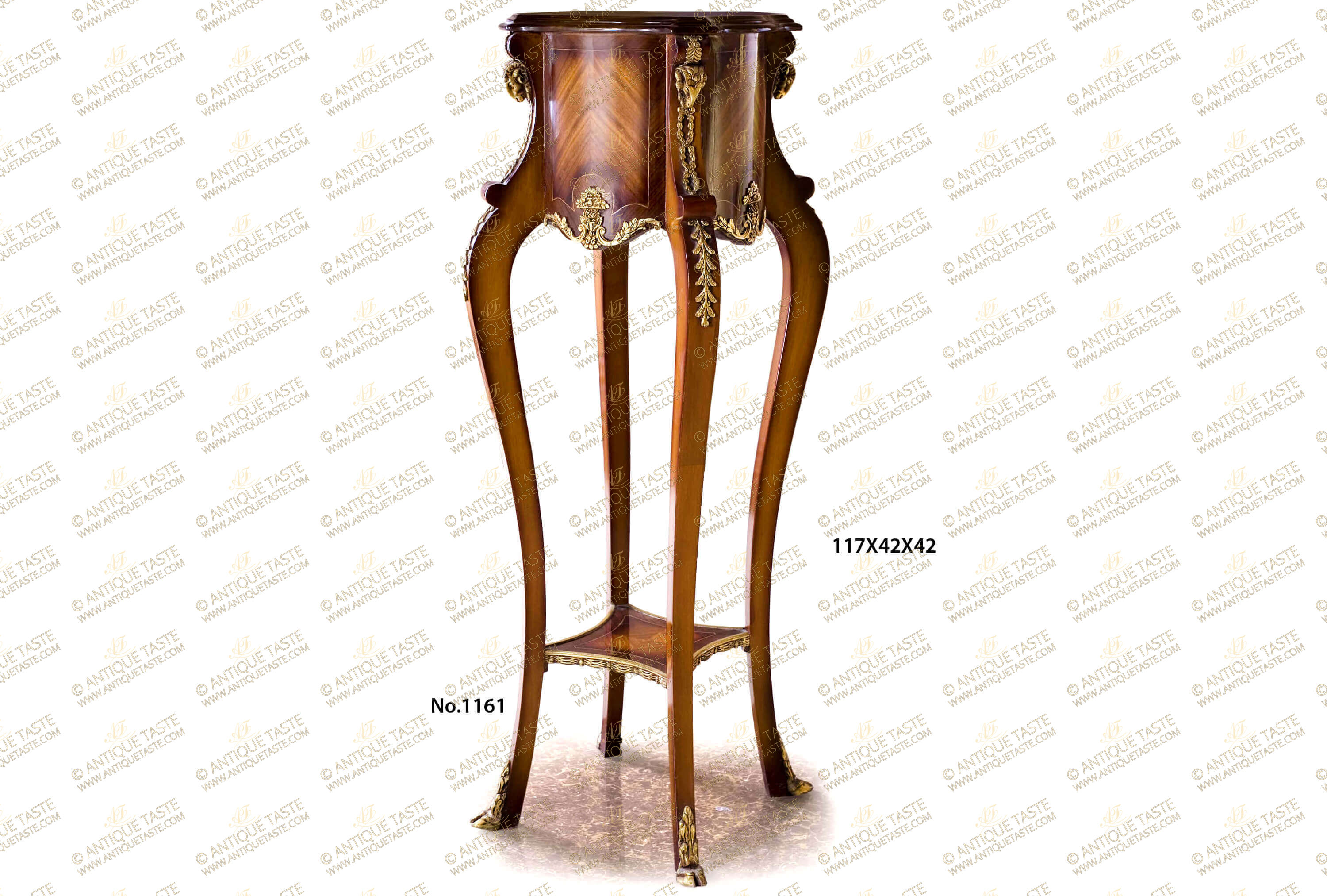 An extremely elegant French mid 19th Century Régence Louis XV early Rococo style ormolu-mounted and sans traverse crossbanded veneer inlaid grand Plant Stand Pedestal; The beautiful pedestal is raised on four convex curved slightly splayed legs adorned with four ormolu leafy hoof feet sabots and connected with a lower tier competently sans traverse veneer and filet inlaid and decorated with handsome swaging draped garlands ormolu mounts; Each leg is leading up transforming to concave shape support tops adorned with imbricated leafy ormolu mounted headed with finely chiseled and most detailed ormolu ram heads surmounted with an ormolu anthemion; the supports are surrounding the thick circular scallop shaped top tier which displays most decorative mottled designs with canted corners; the top tier is beautifully sans-traverse veneer and filet inlaid and ormolu-mounted with exquisite blossoming flower bouquet issuing scrolling acanthus leaves.