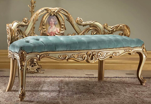 A fascinating, luxurious and unique Italian Baroque and Vernis Martin style Marquise Loveseat Sofa, exquisitely hand carved, French foil parcel gilded, patinated and Green Trianon color painted; carved of the most durable Beech Wood as all our production and raised on most elegant cabriole legs with large richly carved acanthus leaves and beautiful floral acanthus reserves at each corner; the apron display most decorative scrolling shapes with striking foliate designs and central smooth pierced  floral cabochon; the seat is professionally upholstered in tufted style with luxurious royal blue velvet fabric; the extraordinary pierced back has bold and richly carved large scrolling acanthus leaves surrounding an exceptional medallion hand painted with a portrait of a Court Lady. Can be customized to any finishing or upholstery per client's request.