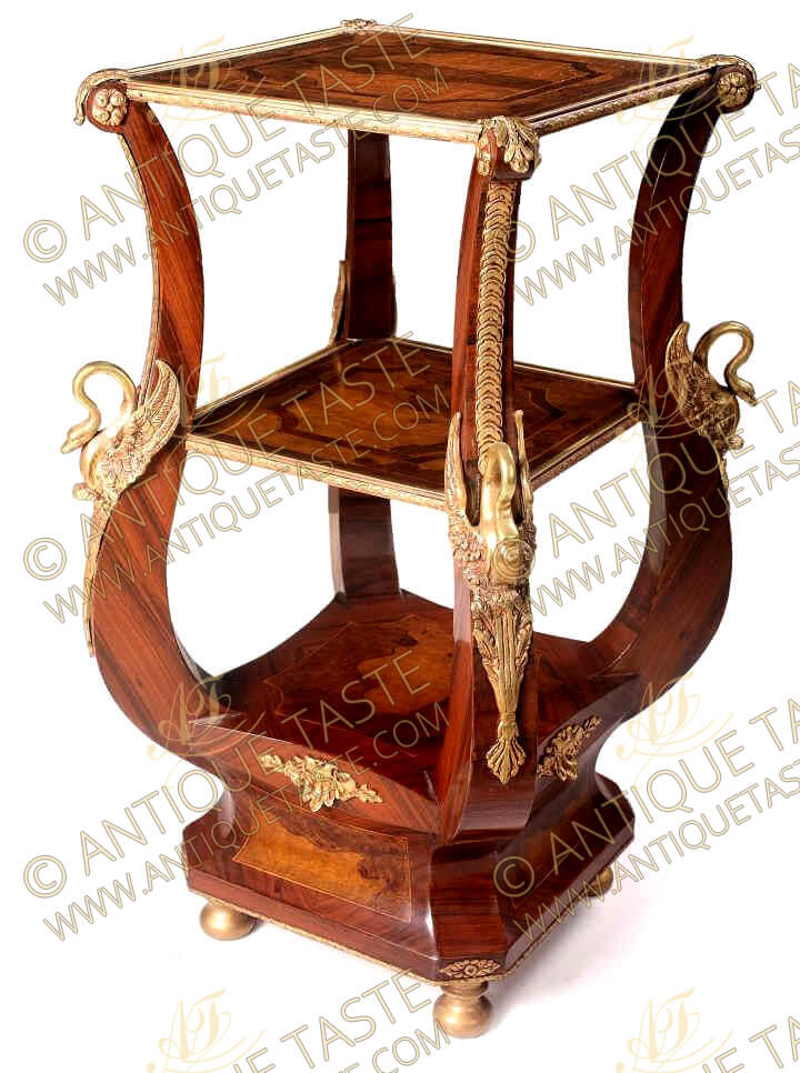 An impressive Italian late Neo-classical style ormolu-mounted veneer inlaid side lyre shaped étagère, The beautiful side table first two tiers ornamented with ormolu hammered galleries, The lyre shaped hipped turned cabriole supports inlaid with acanthus leaves, blossoming rosettes and trailing leafy strip terminating with a sensational accented winged swan on each leg above a concave veneer inlaid plinth with ormolu filet and raised on round gilded bun feet