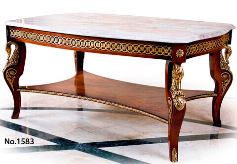 Napoleon Second Empire style ormolu-mounted veneer inlaid Coffee Table, The serpentine shaped eared and moulded marble top above an impressive frieze with recessed panels on all sides separated by blocks on corners ornamented by ormolu rosettes and adorned by most decorative pierced interlocking circle design accented with small leaves, Below are four robust cabriole legs mounted with masterfully chiseled and detailed ormolu Swan busts, adorned on the sides by pierced foliate ormolu mounts and an ormolu acanthus leaf sabot on each leg, The legs are joined by a concaved X stretcher with an ormolu embellished border