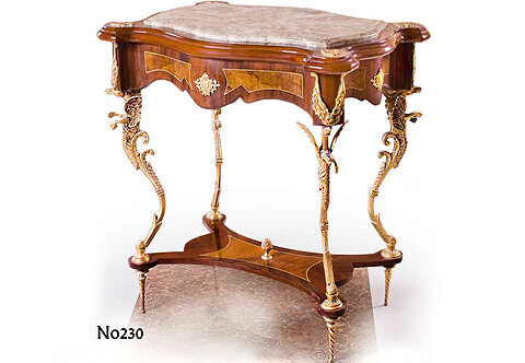 A remarkable French Regence style dragon-ormolu-mounted side table circa 1720, The unique Louis xv style end table with beveled inset marble top inside a leveled eared frieze with ormolu ornamentations, above scalloped apron with double veneer fillet inlaid and central gilt ormolu cartouche, The four sides of the apron decorated with gilt-ormolu foliate pendants above a fine molded four gilt-ormolu winged dragon legs connected with a concave scalloped veneer inlaid stretcher centered with an ormolu pine cone and raised on  a very delicate ormolu twisted legs, The unique table is part of a set including a coffee table of the same design.