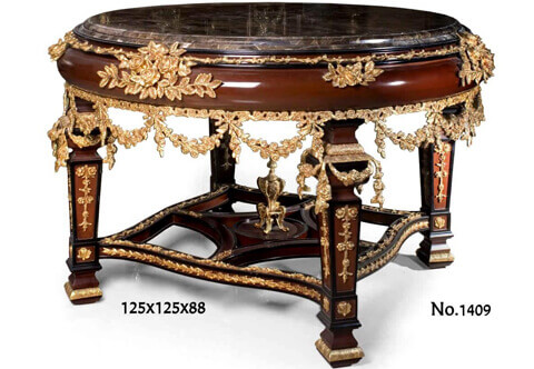 A distinguished and most detailed Louis XIV style gilt-ormolu-mounted mahogany finish Baroque center table, heavily ornamented with pierced works, garlands, swags, strap-works and leaf motifs, The inset beveled marble top with a convex apron ornamented with foliate ormolu filet to the top contour and gilt leafy ormolu works of blossoming flower bouquets and branches. The lower part of the apron is surrounded with an ormolu guilloche frieze of blossoming flowers with garlanded pendants, The table is raised on robust square ormolu mounted tapered legs and connected with pierced sectional curvy X stretcher garnished with ormolu leaf shaped frieze and centered with an ormolu urn of prosperity