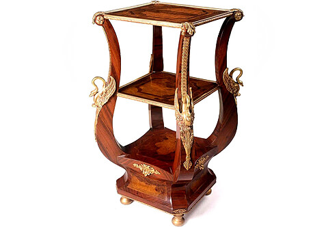 An impressive Italian late Neo-classical style ormolu-mounted veneer inlaid side lyre shaped étagère, The beautiful side table first two tiers ornamented with ormolu hammered galleries, The lyre shaped hipped turned cabriole supports inlaid with acanthus leaves, blossoming rosettes and trailing leafy strip terminating with a sensational accented winged swan on each leg above a concave veneer inlaid plinth with ormolu filet and raised on round gilded bun feet