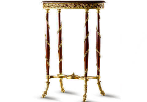 A sensational and delicate museum quality 19th century French Louis XVI style gilt-ormolu-mounted oval shaped guéridon table after the model by Adam Weisweiler, the oval shaped marble top above a conforming frieze finely adorned with intricately chiseled gilt-ormolu guilloche of interlacing scrolling vines, Resting on four slender inflated colonnettes headed with gilt-ormolu tobacco leaf capitals and spiral foliate gilt-ormolu garlands extending to the wonderful curved entwined gilt-ormolu beaded stretcher with a fine central eternal flame, All above finely detailed and shaped gilt-ormolu pied-de-biche cast feet