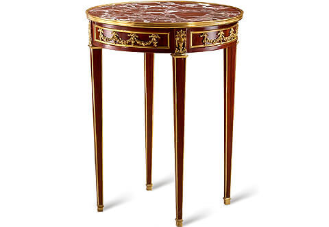 French late 18th century Louis XVI Neo-Classical style gilt-ormolu-mounted veneer inlaid Table Bouillotte after the model by Adam Weisweiler, The inset breche violette marble top within a molded ormolu gallery above a conforming apron, The sectional apron is adorned with fanciful ormolu ribbon-tied garlands surrounded with quarter round ormolu filets; every section is separated by a block ornamented with Neo-Classical style ormolu beaded and reeded vase issuing floral Rinceaux style and bouquet of blossoming foliate branches, The table is raised by fine square tapered legs with square wrap around ormolu sabots and ormolu bands on the four corners of each leg extending to the top ormolu cap
