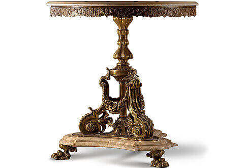 An alluring French Louis XVI style distressed ormolu Guéridon, The circular beveled marble top above an intricately detailed chiseled apron resting on a bulbous gadrooned form support continues suspending imbricated blossoming floral garlands, acanthus form modillions, acanthus leaves scrolling volutes, all on a tripartite Torus form marble base resting on three leafy ormolu paw feet